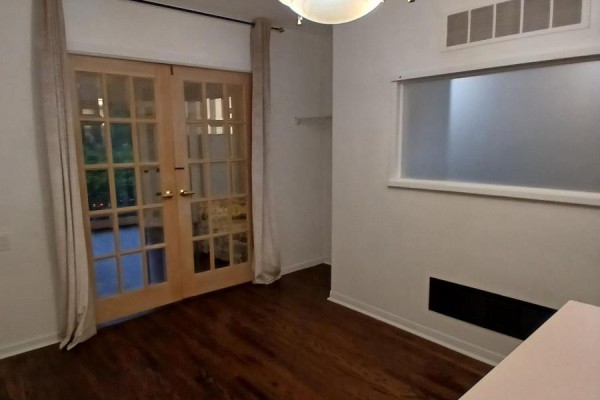 A room with hardwood floors, French doors, and a frosted window. - 9 Ivan Nelson Drive, Toronto