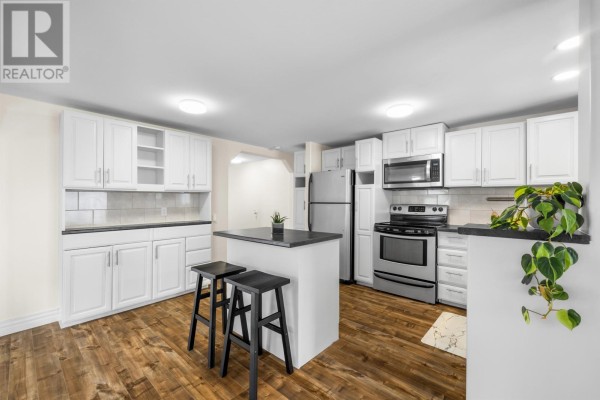 Open layout showing dining area and entrance, with plants and storage unit - 9 Linkletter Estates, Summerside