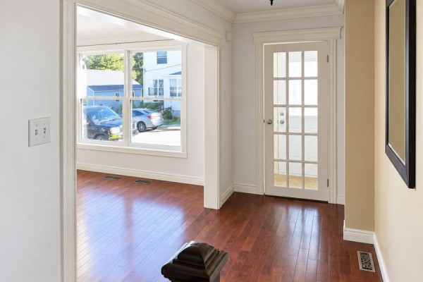 View from the living room through a doorway to the entryway and front door. - 9 Malta Street, St  John S