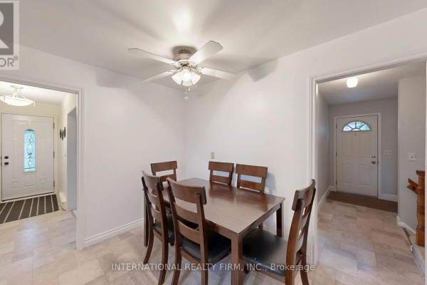 Square dining table with six wooden chairs in a room with beige tiled floor. - 9 Vaughan Avenue, Port Hope