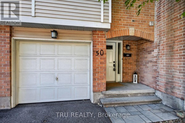 Close-up of garage door and front entrance of townhouse number 50. - 90 - 50 Lightfoot Place, Ottawa
