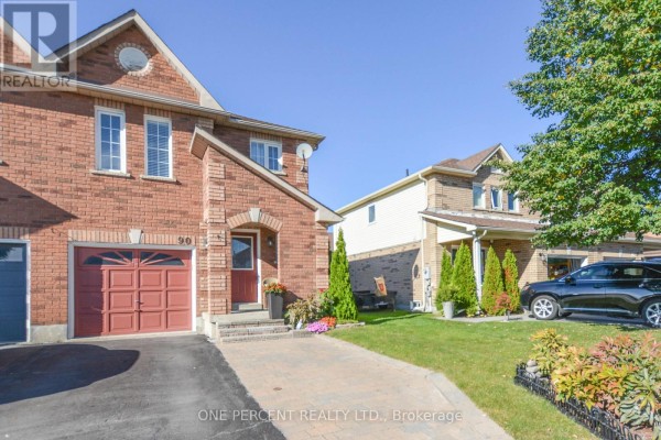Side view of the red brick semi-detached house and a neighbouring house. - 90 Breeze Drive, Bradford West Gwillimbury