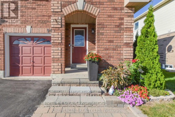 Entrance to the red brick semi-detached house with a red door and stone steps. - 90 Breeze Drive, Bradford West Gwillimbury