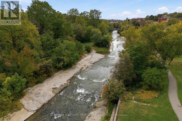 Aerial view of a river flowing through a park with trees on the banks. - 90 Brown Street, Port Hope