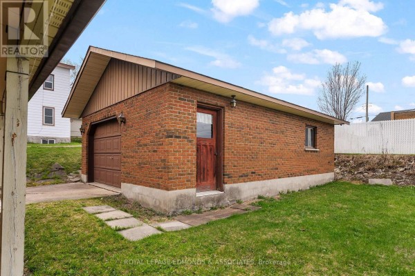 Exterior view of the home featuring a carport and landscaped front yard. - 90 Deacon Street, Pembroke