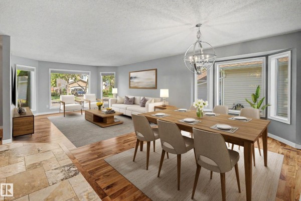 Living and dining room with bay windows, wood floors, stone tile, and a chandelier. - 90 Dufferin St, St  Albert