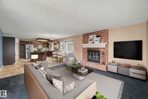 Family room with a brick fireplace, open kitchen, and stainless steel appliances. - 90 Dufferin St, St  Albert