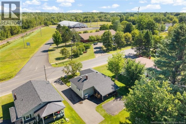 Aerial view showing houses, trees, a road, and distant buildings with a railway line. - 90 King Street, Chipman