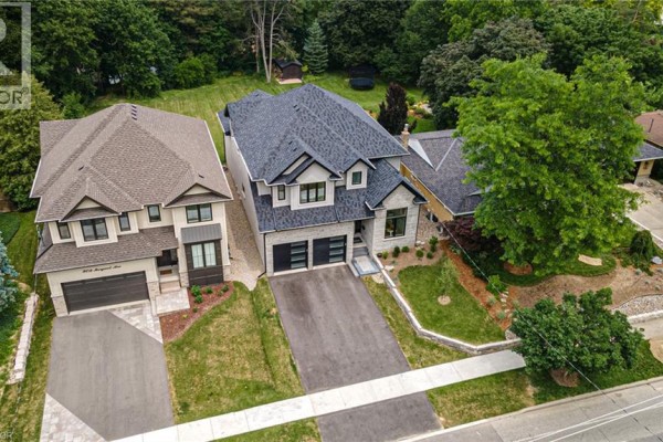 Aerial view of two modern houses side-by-side on a tree-lined street. - 90 Margaret Avenue N Unit# A, Waterloo