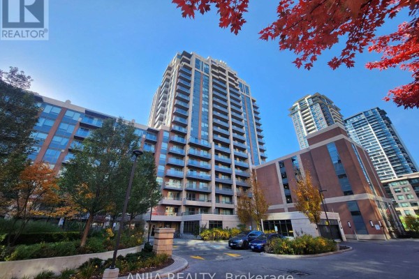 Exterior view of Riverwalk condos with glass balconies and autumn foliage. - 901 - 18 Uptown Drive, Markham