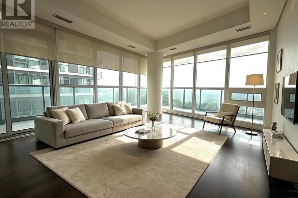 Living room with a large sectional sofa, armchair, coffee table, and floor-to-ceiling windows. - 901 - 35 Brian Peck Crescent, Toronto