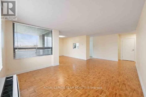 Living room with large windows, a hardwood floor, and white walls. - 901 - 40 Arthur Street, Ottawa