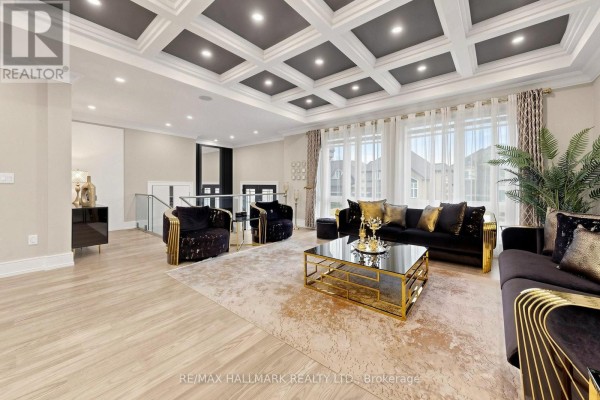 Living room with coffered ceiling, black furniture with gold accents, and large rug. - 901 Wingarden Crescent, Pickering