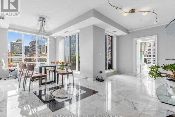 Living and dining area with white marble floors, large windows, and city views. - 902 - 18 Beverley Street, Toronto