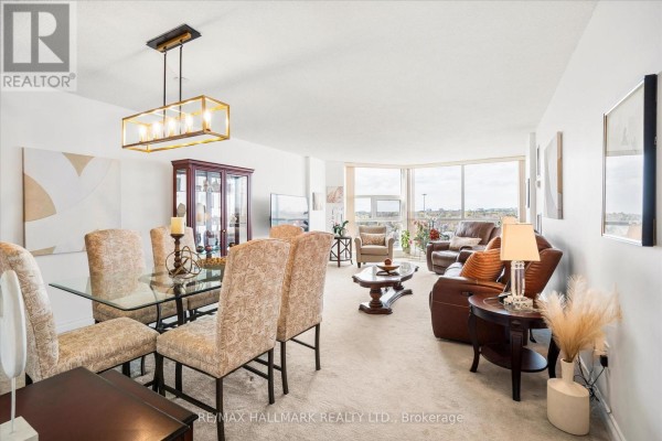 Room with floor-to-ceiling bookshelves on both sides and a table with chairs. - 902 - 20 Dean Park Road, Toronto