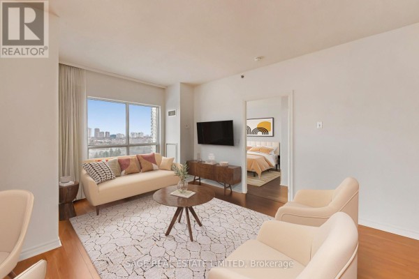 Building lounge with fireplace, built-in shelving, television, and seating. - 902 - 810 Scollard Court, Mississauga