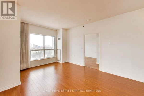 Open concept living and dining area with hardwood floors and large windows. - 902 - 810 Scollard Court, Mississauga