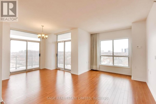 Interior building hallway with carpeted floors and wall-mounted lights. - 902 - 810 Scollard Court, Mississauga