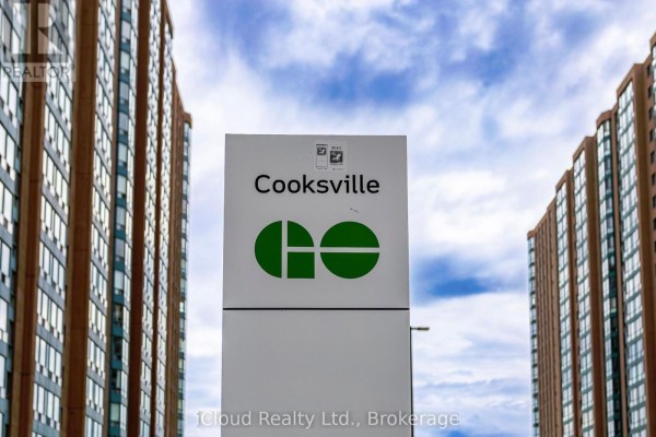 Cooksville GO station sign between two tall apartment buildings. - 903 - 135 Hillcrest Avenue, Mississauga