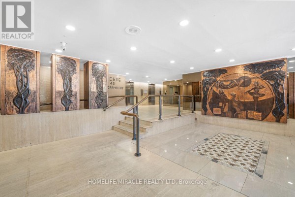 Long interior hallway with white textured walls and grey patterned carpet. - 903 - 40 Panorama Court, Toronto