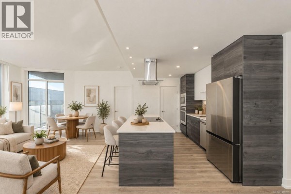 Modern kitchen with a large island, stainless steel appliances, and grey cabinetry. - 904 1628 Store St, Victoria