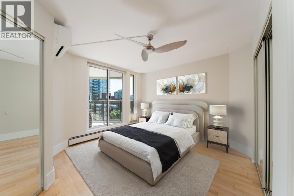 Bedroom with queen bed, bedside tables, and sliding glass door to balcony with city view. - 905 1010 Burnaby Street, Vancouver