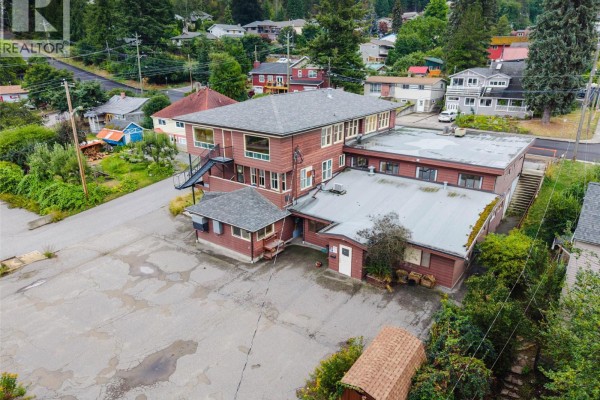 Aerial view of the commercial building showing the parking lot and surrounding residential area. - 905-909 Gordon Street, Nelson