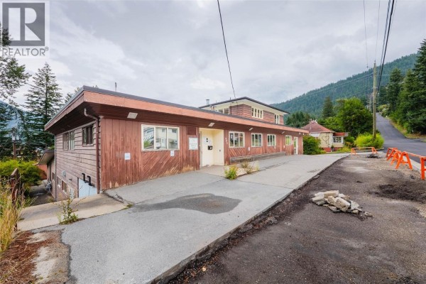 Exterior view of the one-story section of the commercial building with wood siding. - 905-909 Gordon Street, Nelson