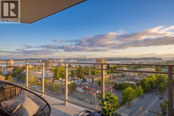 Balcony seating area with views of downtown Vancouver and city street. - 906 112 E 13th Street, North Vancouver