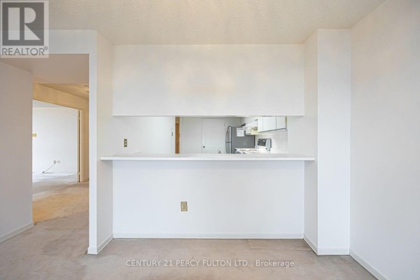 Building gym with various exercise machines, weight racks, and mirrored walls. - 907 - 5 Kenneth Avenue, Toronto