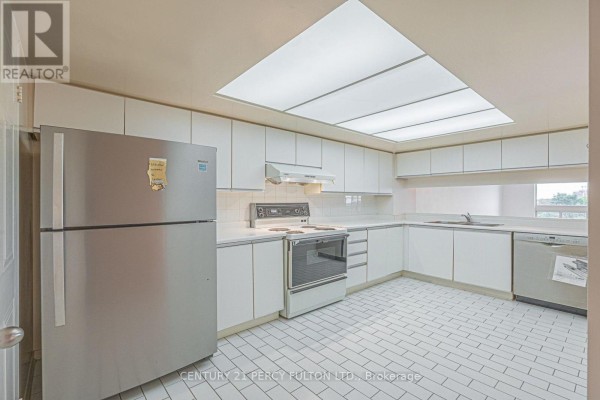 Living and dining area with a sofa, television, and a round dining table with four chairs. - 907 - 5 Kenneth Avenue, Toronto