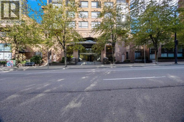 Street view of the apartment building entrance with trees and sidewalk. - 907 1189 Howe Street, Vancouver