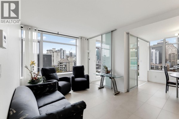 Living room with black furniture, large windows, and sliding glass doors leading to another room. - 908 1028 Barclay Street, Vancouver