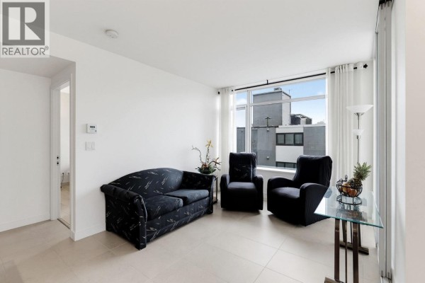Living area with sofa, chairs, glass table, and large window with city views. - 908 1028 Barclay Street, Vancouver