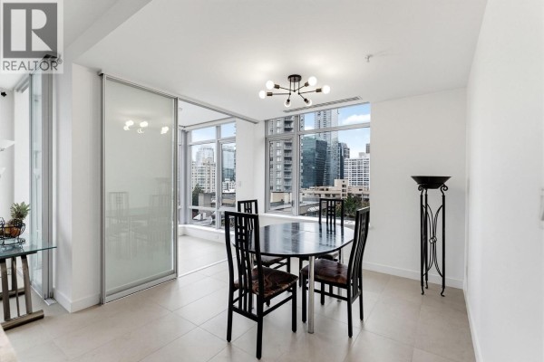 Dining area with black table and chairs near windows offering city skyline views. - 908 1028 Barclay Street, Vancouver