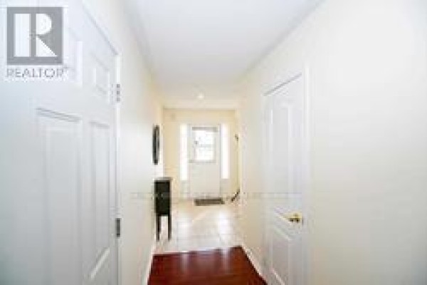 Hallway with cream walls, tile floor, and white doors leading to rooms. - 91 - 6399 Spinnaker Circle, Mississauga