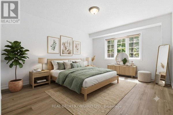 A bedroom with a king-size bed, wood furniture, and light wood flooring. - 91 Lynch Circle E, Guelph