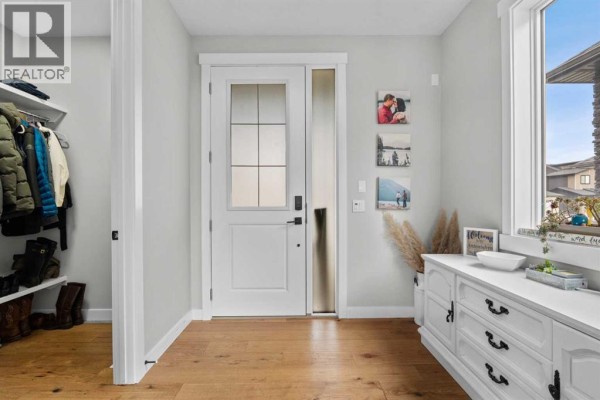 Entryway with a glass-paneled door, a large closet, and decorative white cabinetry against a light grey wall. - 91 North Bridges Road, Langdon