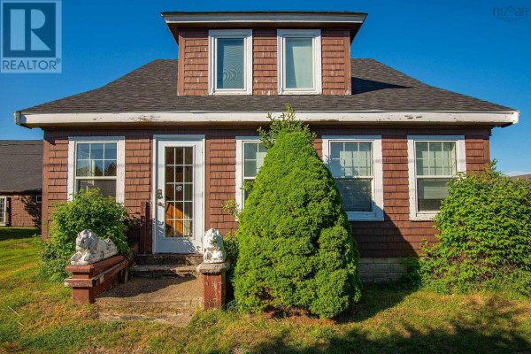 Room with polished wood floors, wainscoting, glass-paned pocket doors, and a large wooden cabinet. - 91 Townshipline Road, Weymouth
