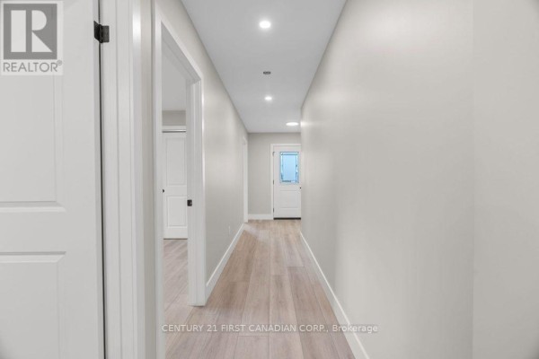 Hallway with recessed lighting and hardwood floors - 91 Victoria Avenue E South Huron