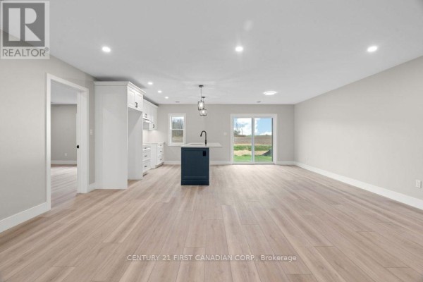 Modern kitchen with island and sliding glass doors - 91 Victoria Avenue E South Huron