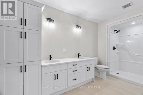 Modern double vanity, walk-in shower, and white shaker cabinets - 91 Victoria Avenue E South Huron