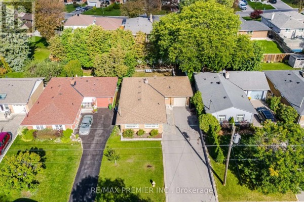 Aerial view of 91 Wigmore Drive and surrounding detached homes on a tree-lined street. - 91 Wigmore Drive, Toronto
