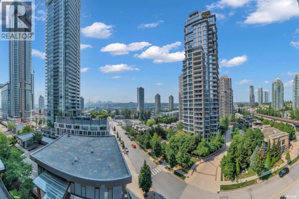 Living room with mounted TV, white console, sectional sofa, and expansive city view. - 910 2008 Rosser Avenue, Burnaby