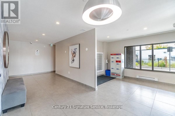 Mailroom with lockers, seating area, and large windows - 911 - 716 Main Street E, Milton