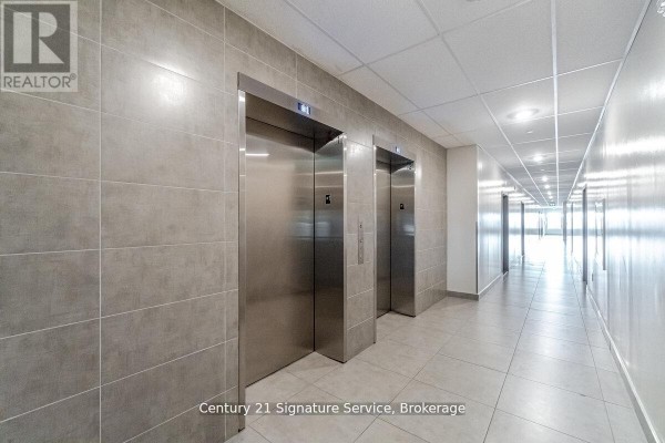 Hallway with two elevators and tiled flooring - 911 - 716 Main Street E, Milton