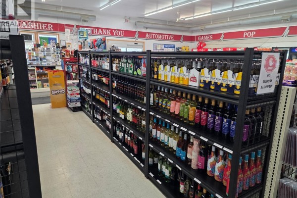 Retail store aisle with shelves stocked with bottles of wine and liquor. - 911 18 Highway, Carnduff