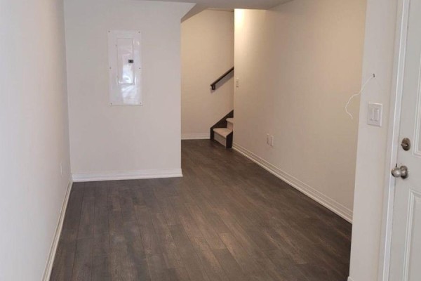 Interior entryway with dark wood flooring, white walls, and a view of stairs. - 913 - 585 Colborne Street E, Brantford