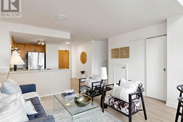 View of an open-concept living area and kitchen. - 913 - 77 Lombard Street, Toronto
