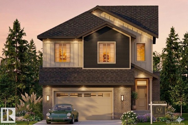 Front exterior of a modern two-story house with a dark grey roof, beige siding, dark grey accent siding, and brick lower level. - 9142 104 St, Morinville